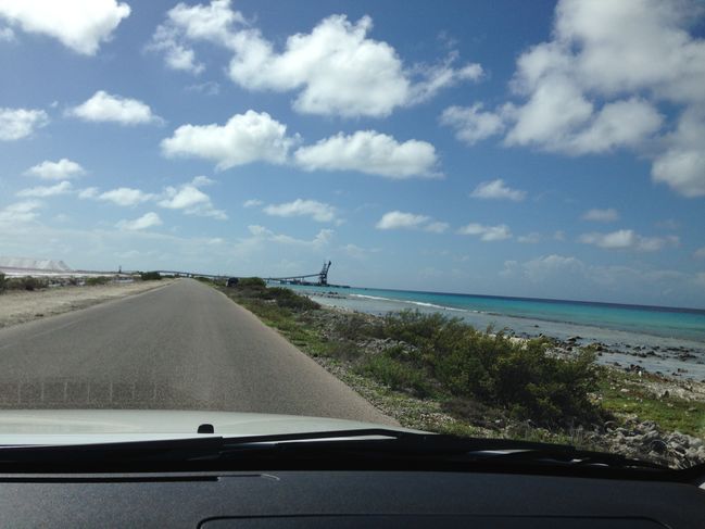road between salt pans and sea
