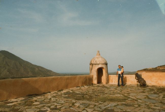 Paul holding 2 year old Jenny in Castillo San Antonio De La Eminencia in Cumana
