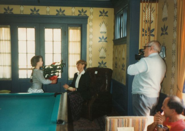 Jenny presenting flowers to Phyllis Kraunz, her teach, George Gerzon filming, Paul watching
