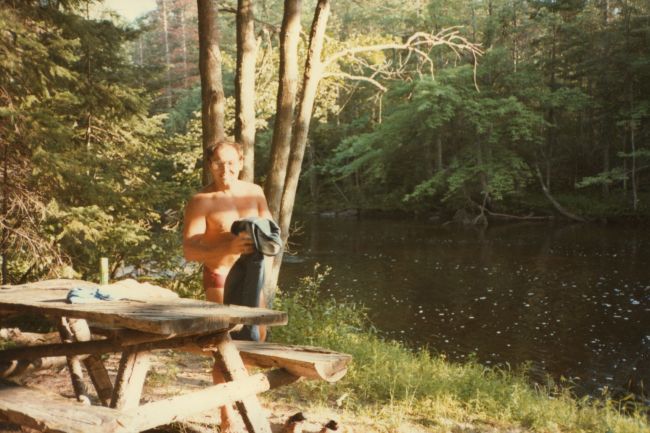 Paul by our hand-made picnic table from local trees
