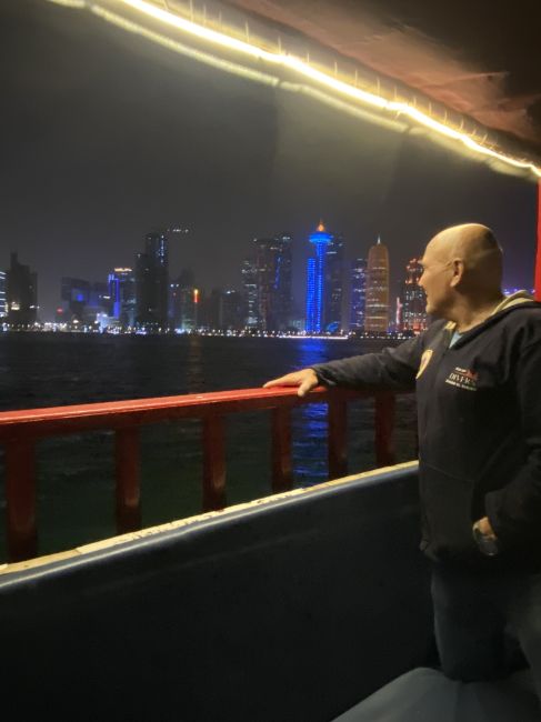 2/1/23 Paul on tour in Doha, Qatar.  In a boat out in the Persian Gulf looking back at Doha.
