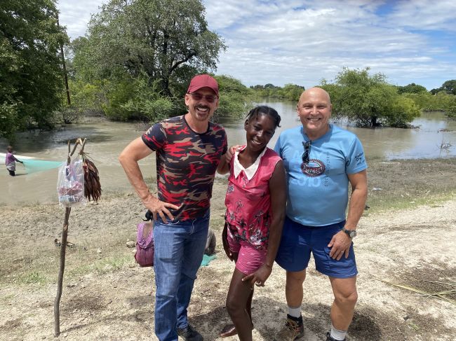 2/4/23.  In Angola, driving north from Namibia border. This girl was fishing from a culvert.  She tried to sell us some local juice made from the swamp water.  We politely declined.
