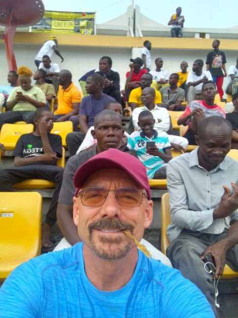 2/12/23 Paul at soccer stadium on the outskirts of Brazzaville.  We were the only two white people in the 5,000 seat stadium
