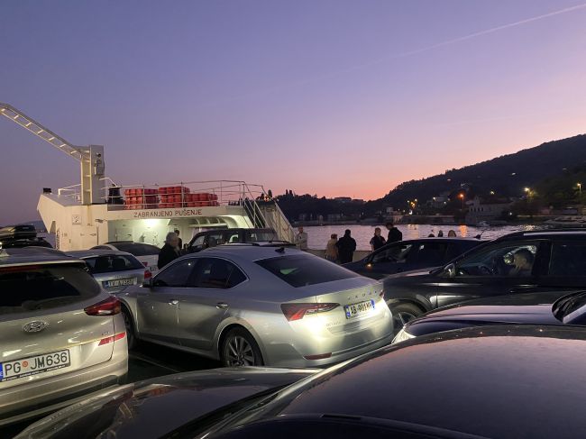 Ferry crossing arm of sea as we approach Budva, Montenegro (our car is silver Skoda)
