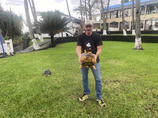 Ray playing with large land turtle on lawn behind our hotel in Comoros
