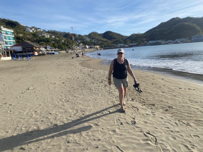2/15 Helen walking on the beach in Roatan, Honduras
