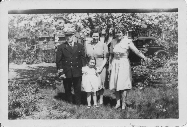 Otto Goranson on the left and on the far right is Signe Goranson (later marrided Marvin Peterson)
From Elaine Goranson Seher: The picture is from 1943.  It was taken in the backyard of Pop and Alice's home on Elliot Ave.  The car is in their driveway, which extends behind them and continues beyond the pic until it reaches the garage, which would be on the left of the shot (obviously not included in the pic).  Extra, unasked for details: pop is wearing his Coast Guard uniform.  He volunteered to serve in WWII and was an engineer on a ship.  He got the nickname "pop" from the younger men on the ship
