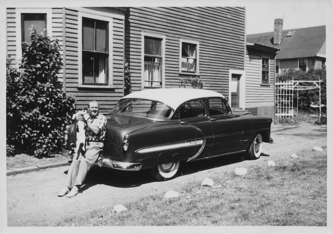 Ake with brand-new Sonya sitting on 1953 Chevrolet Belair in Adamson St. driveway fall 1959
