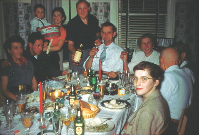 Greta, Paul Holman, baby Paul Niel, Lynne, Ake with Akvavit, Marvin and Signe Pedersen, Alice, Otto (Pop), Roslalie, in Allston dining room, ca 1955 (Walter probably took the photo)
