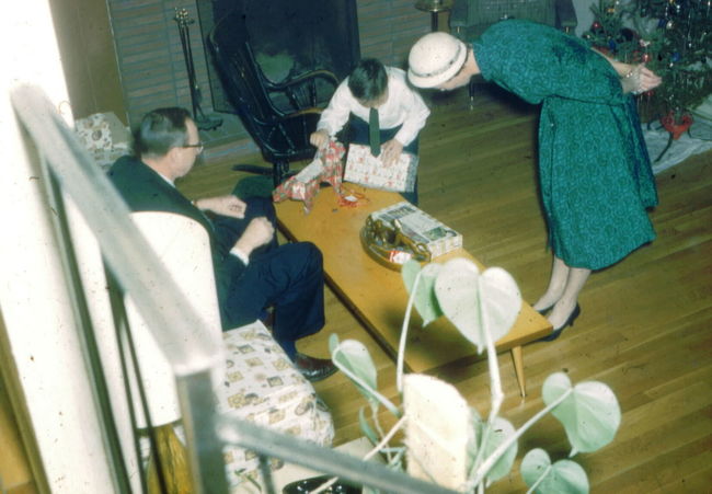 Walter and Peggy Paulding (architect friend of Ake) giving Paul XMAS presents early 1960's in Cynthia Road living room
