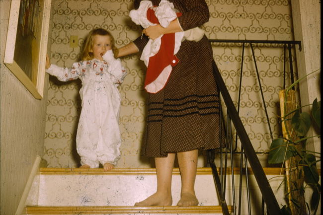 Faith Freda and adult descending stairs in 13 Cynthia Rd.
