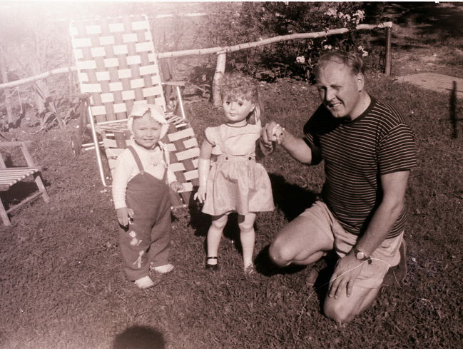 Leslie, her bigger-than-her doll and Ake, 13 Cynthia back yard, ca 1962
