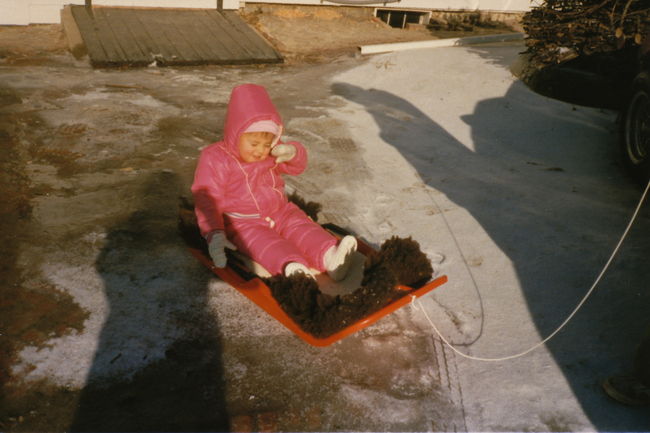 Jenny on sled in front of EL Xmas 1985
