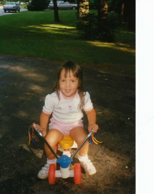 Jenny on Peter's tricycle, 13 Cynthia Rd. driveway ca 1989
