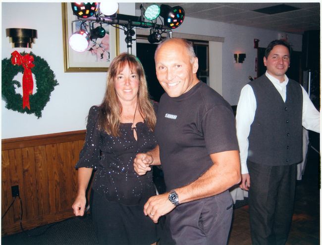 Paul and Helen with Anthony Delli Colli in background at 2005 Meetinghouse Christmas Party
