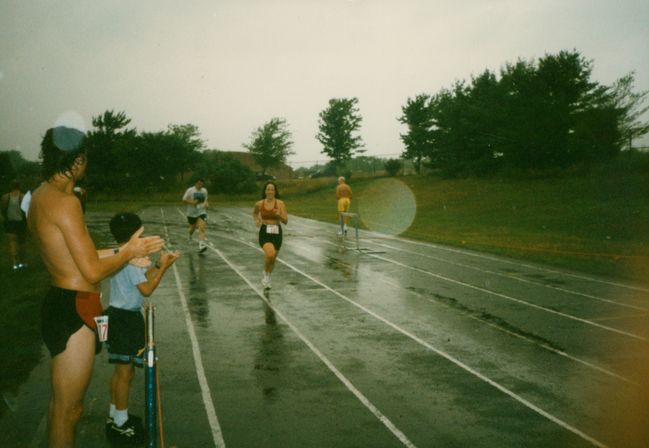 Helen finishing 1991 Tony Sapienza 5k in Haverhill while Paul and Peter watch
