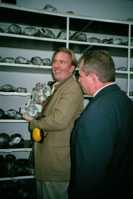 Christopher Radko with plant manager inside ornament factory
