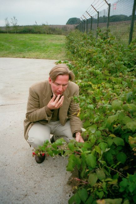 Christopher sharing fruits from raspberry canes 
